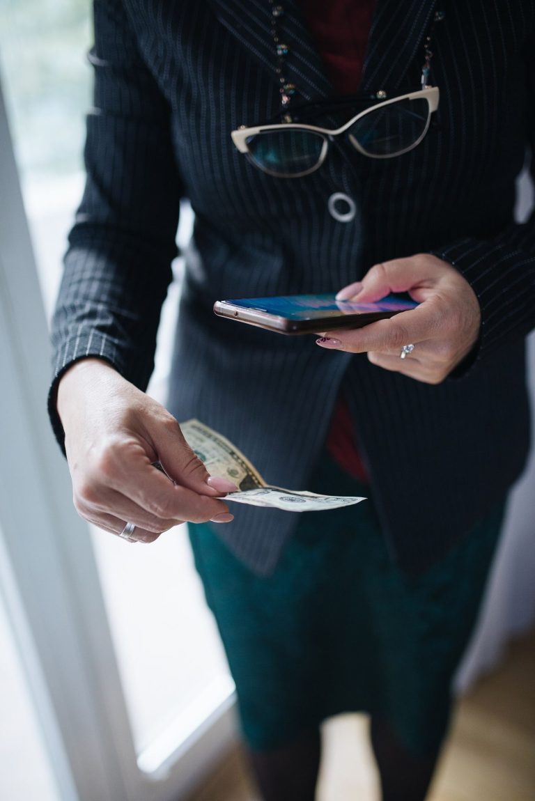 Smartphone Payments Are Replacing Cards and Cash at Tills A shopper pays at a checkout by holding a smartphone near a payment terminal.
